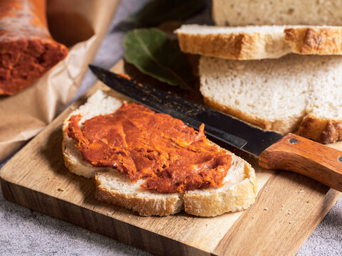 Mallorcan sobrasada spread on rustic bread with knife, traditional Spanish cured sausage concept