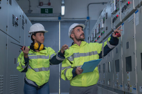 engineer working on the checking status switchgear electrical energy distribution substation	