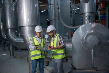 Naklejka premium Mechanical engineer Checking of centrifugal pump in pump room. worker working in plant room.