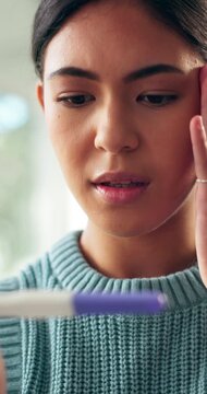 Regret, pregnancy test and woman with shock in home with stress, upset or mistake for unplanned maternity. Anxiety, scared and female person with positive result for failed birth control in house.
