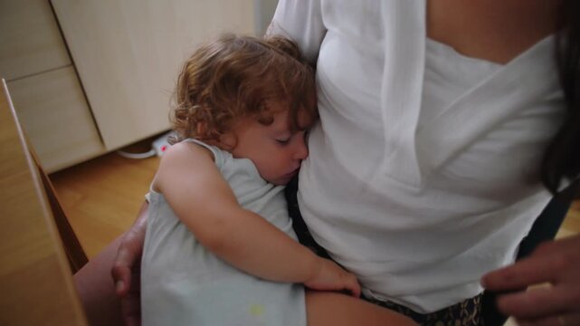 Toddler asleep while nestled against mother body expressing deep comfort trust and secure attachment capturing intimate moment of rest and emotional bonding in quiet home setting