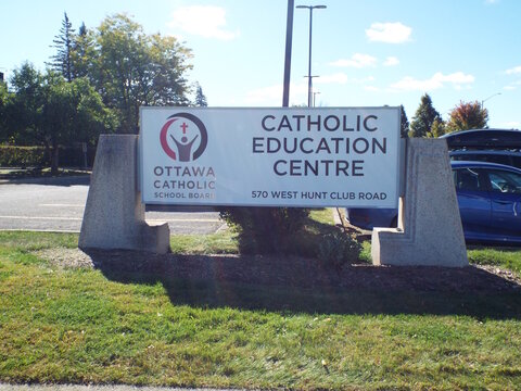 Nepean, Ontario, Canada &ndash; July 28, 2025: The "Ottawa Catholic School Board's Catholic Education Centre "sign is displayed at 570 West Hunt Club Road on a lawn on W Hunt Club Rd. 