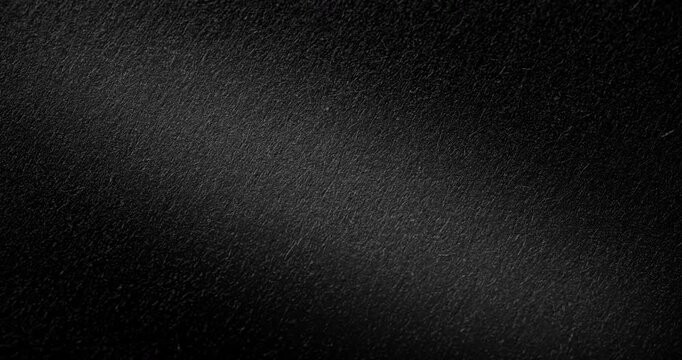 Abstract black texture. Slow Diagonal Panning. The slow, smooth diagonal movement of a dark, rough surface moving in a soft beam of light.