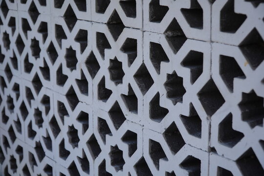 White Islamic geometric star pattern roster wall texture, architectural ventilation panel, traditional arabic ornament, mosque decoration, and background concept.