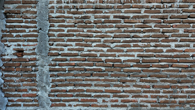 Textured brick wall with earthy tones and surface details showcasing urban architecture