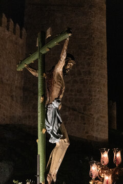 A large crowd gathers at dawn in Avila for the Penitential Via Crucis. The ancient Christ of the Executed statue is paraded along the city walls in a deeply traditional Good 