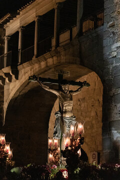A large crowd gathers at dawn in Avila for the Penitential Via Crucis. The ancient Christ of the Executed statue is paraded along the city walls in a deeply traditional Good 