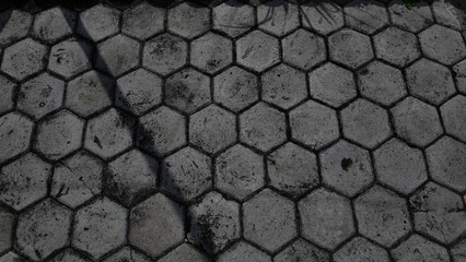 Fototapeta premium Close up view of weathered hexagonal pavement tiles with textured surface and urban aesthetic