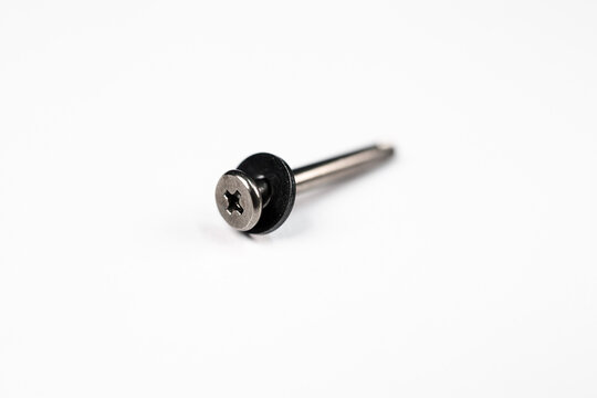 Macro Closeup of a Single Long Torx Screw with black Washer on a white background. This is a computer screw used in a CPU Fan or Electronics.