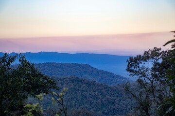Obraz premium Beautiful sunset over the layered silhouettes of the Andes mountains in Argentina, featuring a purple and orange sky over a wild highland landscape