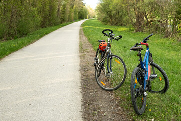 Fototapeta premium Two bikes parked on the side of a rural asphalt road.