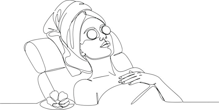 Woman with towel and eye patches relaxing in spa treatment.