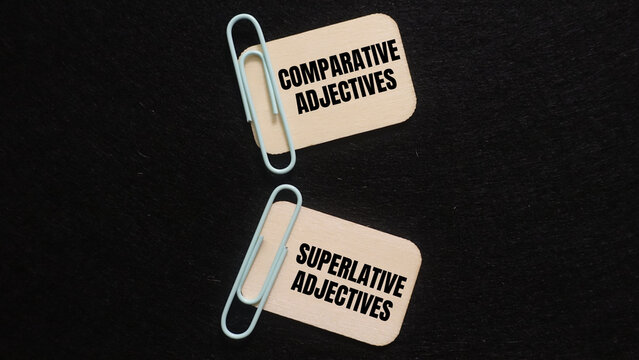 Cards labeled comparative adjectives and superlative adjectives on dark background