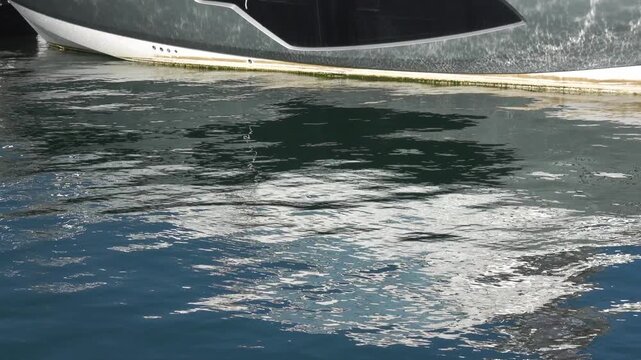 Boat is at the harbor, water reflects sunlight