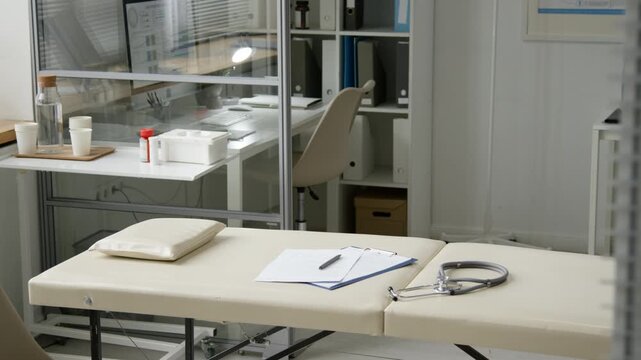 No people shot of stethoscope and medical documents resting on examination table in private area of modern clinic