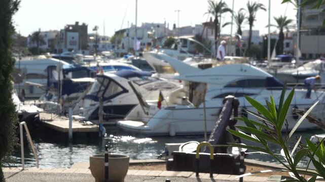 Boats moored; people walk nearby. Empuriabrava, Spain