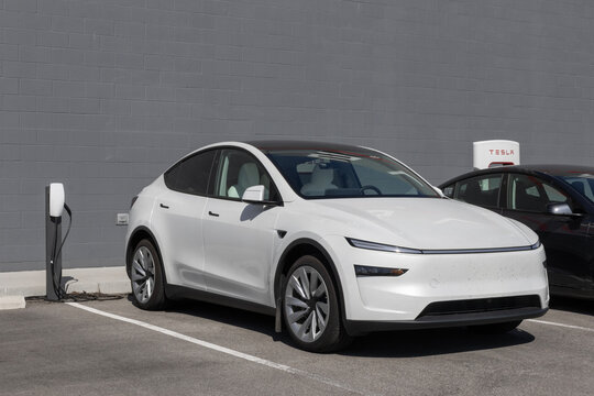 Tesla Model Y display at a dealership. Tesla offers the Model Y with up to 327 miles of driving range. MY:2026