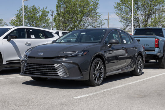 Toyota Camry XLE AWD sedan at a dealership. Toyota offers the Camry with a 2.5L 4-Cylinder Hybrid engine. MY:2026