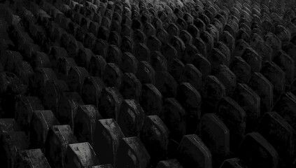 Obraz premium Aerial view of an intricate pattern of dark, textured rows resembling a series of aligned circular objects, creating a rhythmic composition