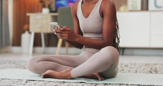 Yoga, hands and typing with phone in home for practice break, texting and research fitness tips. Woman, mobile app and browsing in house for online exercise guide, chat response and wellness article
