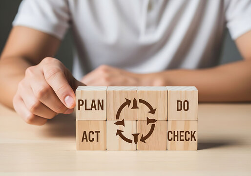 Person holding wooden blocks with plan do check act text