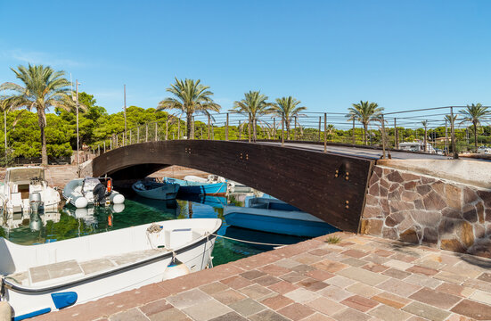 The characteristic wooden bridge over the Porto Pino canal, located in the municipality of Sant'Anna Arresi, Sardinia, Italy.