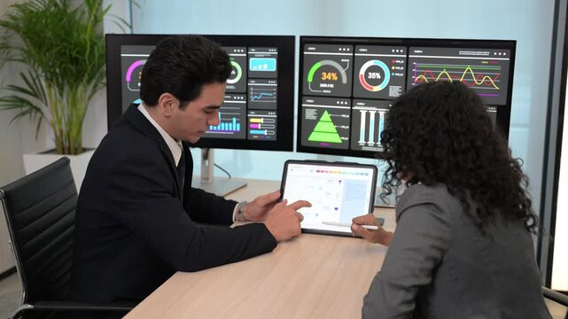 Diverse business team professional data analysts working together in office using tablet digital dashboard for financial marketing growth research. Expert colleagues analyzing corporate infographic ch