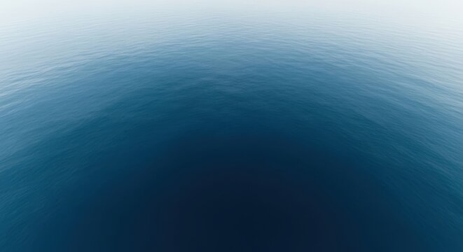 Calm ocean waves gently lap against the shore at sunrise