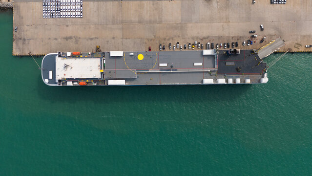 aerial view of new cars parked at the parking area of automobile factory, waiting for RORO transport of international