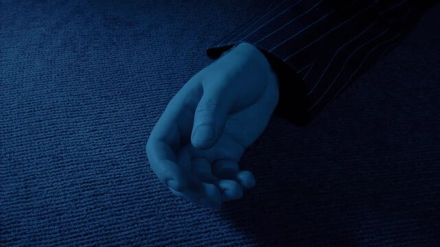Man In Jacket Falls On Carpet In Dark Room