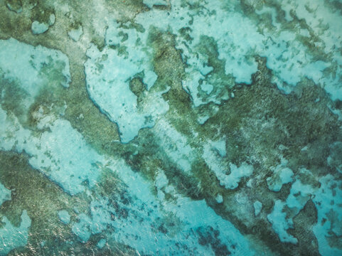 Aerial view of the coral reef and crystal clear turquoise water at Anse Source d'Argent in L'Union Estate, Seychelles.