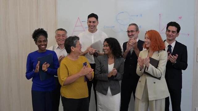 Successful diverse business team clapping hands and laughing in office, happy multicultural professional coworkers celebrating corporate achievement and victory, group of partners applauding together.