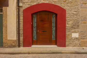 Fototapeta premium elements of architectural decorations of buildings, old doors with arches, gates and doorknob, on the streets in Barcelona, public places.