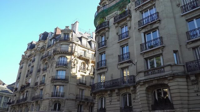 Classic Parisian architecture, historic facades with wrought iron balconies in Paris, France.