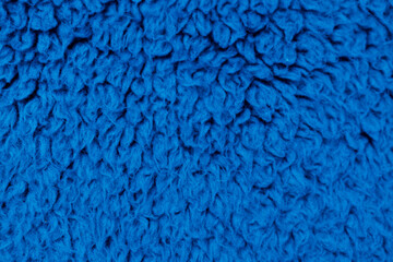 Blue long pile fuzzy fabric texture close up soft plush background © Iryna Miadzvedzeva