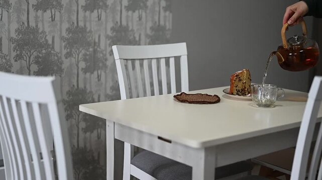 Enjoying tea and cake at a simple table with a warm setting in the afternoon