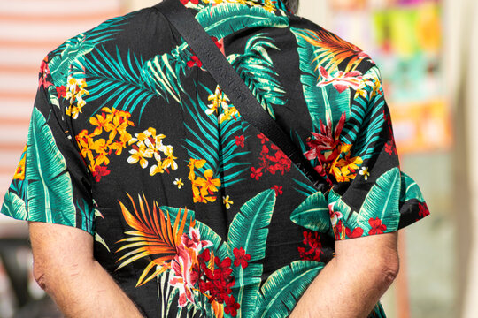 Back view of a person in tropical floral clothing The Concept of vacation and travel