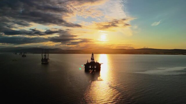 Aerial drone view of oil rigs at sunset in Cromarty Firth, Highlands, Scotland