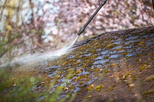 Ein Hochdruckreiniger auf einem Dach im Garten zum reinigen vom Moos.