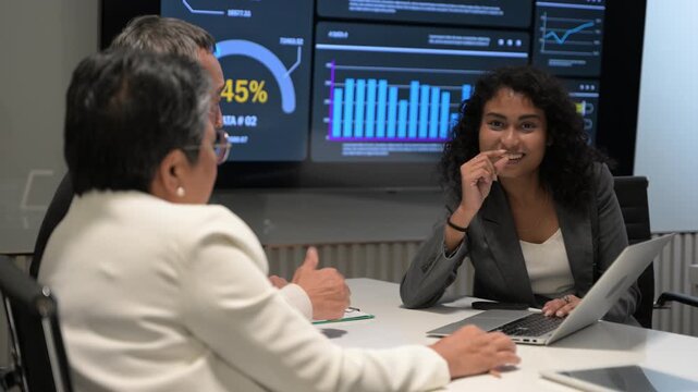 Business team meeting with presenter explaining data analytics dashboard on large screen. Charts, graphs, and performance metrics highlight corporate strategy, teamwork, and modern business intelligen