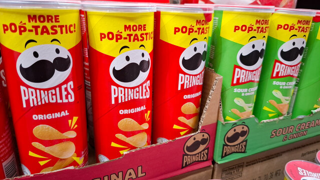 Row of Pringles Potato Crisp Tubes Featuring Original and Sour Cream Flavors on Retail Supermarket Shelf for Global Snack Food on April 17, 2026 in Bangkok, Thailand