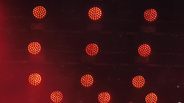 Red LED stage lights illuminating a concert venue for a dance music performance