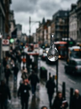 Surreal Urban Reflection: Giant Water Drop over Busy City Street