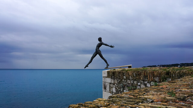 Antibes, France - March 10, 2026: Sculpture named Le Defi or The Challenge in the walls in the old town. The art by Nicolas Lavarenne is aligned with the horizon, creating a beautiful visual effect.