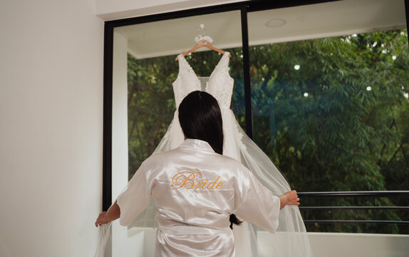 woman touching her white wedding dress