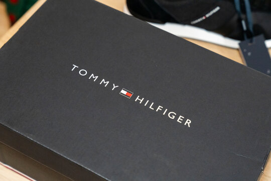 Warsaw, Poland - April 20, 2026: Close-up of a Tommy Hilfiger box placed on a wooden surface, showcasing the iconic logo and branding, highlighting premium fashion and lifestyle.