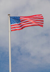 Obraz premium Flag of the United States of America at Tall Mast Clouds