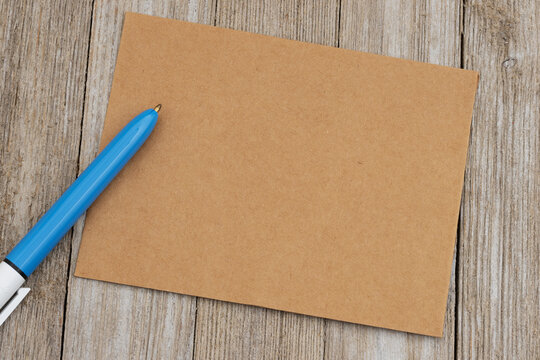 Blank brown card mockup with blue pen