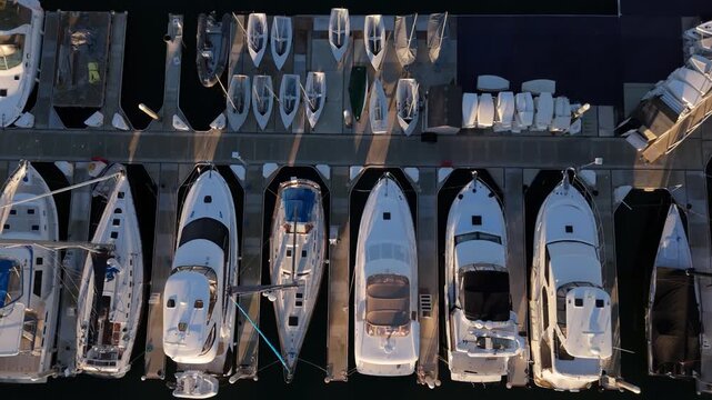 Top down aerial view of luxury yachts docked in marina harbor geometric pattern boats background