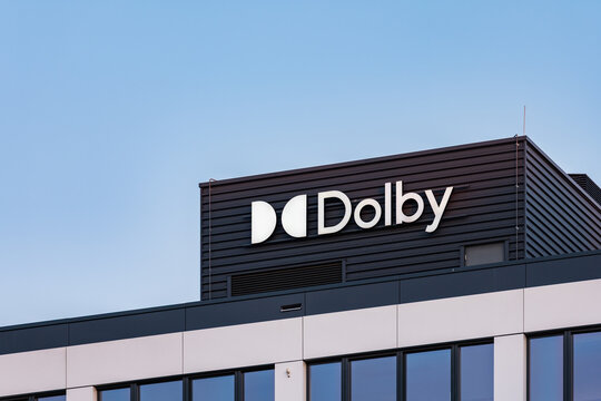 Wroclaw, Poland - March 27 2025: Dolby Company Logo on Modern Glass Office Building in Wroclaw Poland at Sunset Contemporary Corporate Architecture and Branding in Golden Hour Urban District